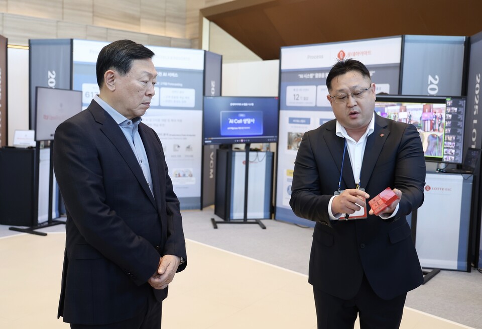 신동빈 롯데 회장(왼쪽)이 롯데케미칼의 'AI 기반 컬러 예측 시스템'에 대한 설명을 듣고 있다. / 사진=롯데
