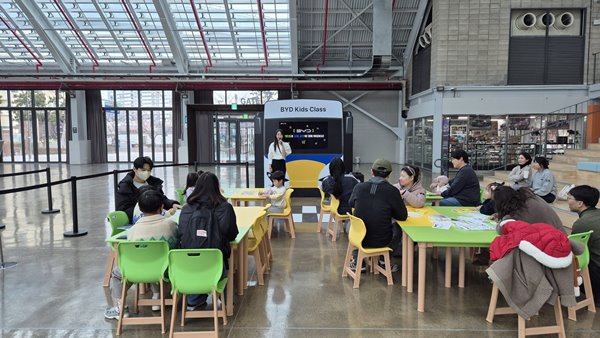 현장 요원이 어린이 방문객을 대상으로 BYD와 전기차에 대해 설명하고 있다. / 사진=최동훈 기자